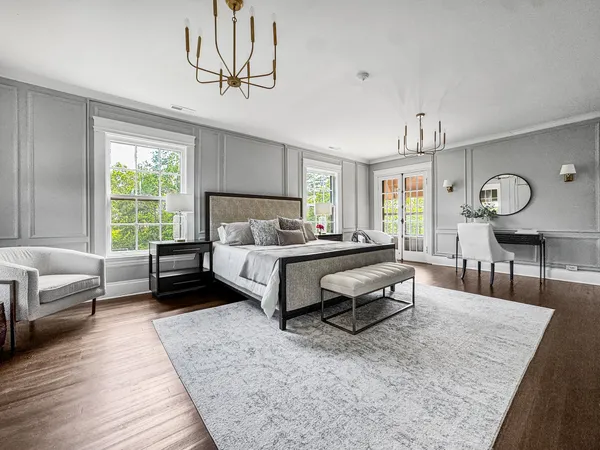 a spacious bathroom with a double vanity sink a mirror and a bathtub