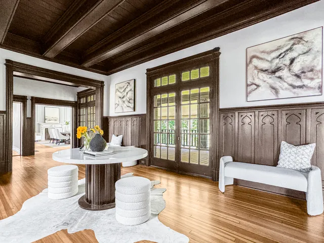 a living room with furniture a window and wooden floor