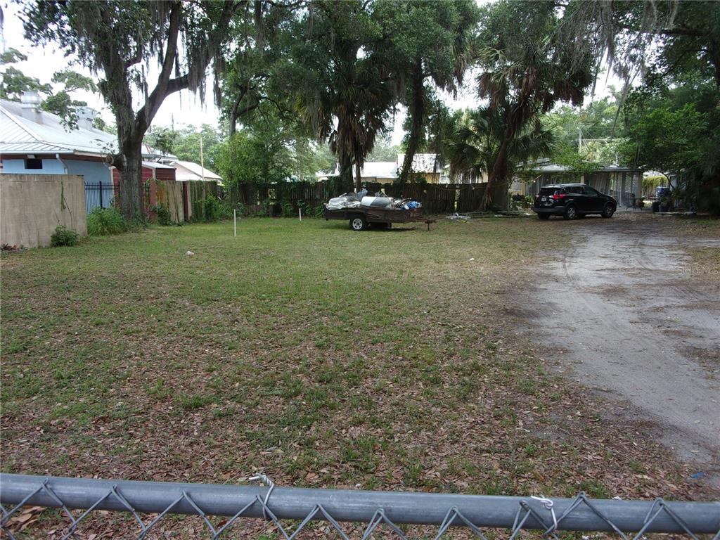 a view of a yard with a house and a tree