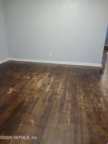 a view of room with wooden floor