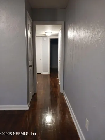 a view of gallery with wooden floor