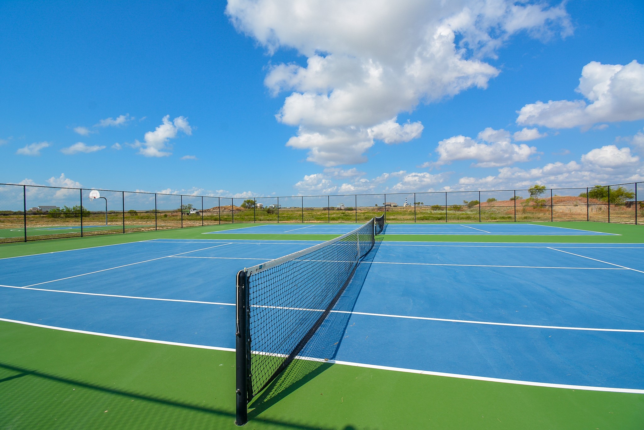 3036 Sandy Lane Palacios, TX 77465 - Photo 15 of 32 a view of an outdoor space and tennis court