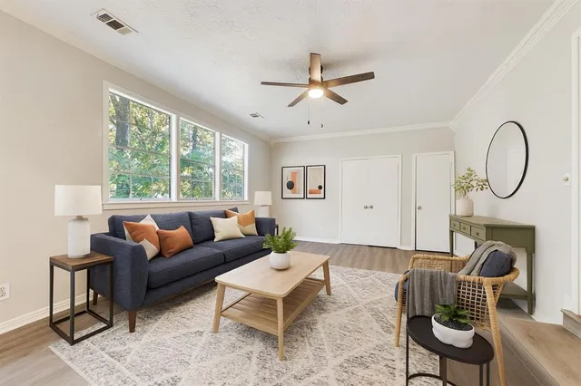 a living room with furniture a fireplace and a large window
