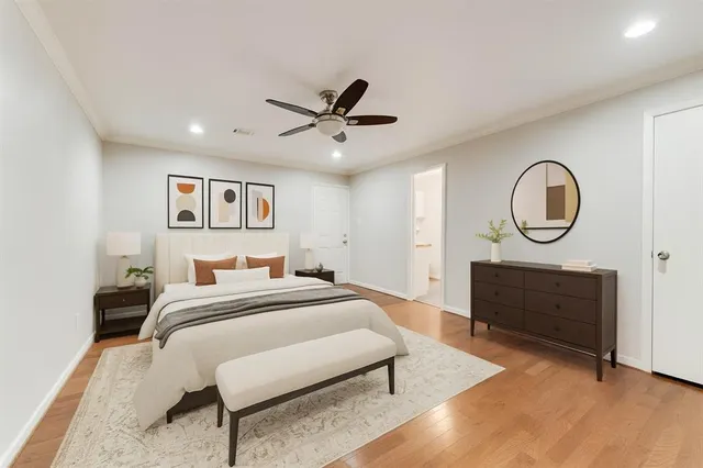 a bed room with a bed a mirror and a dresser