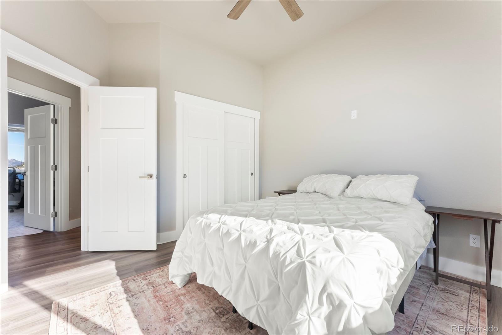 489 Duesouth Road Florissant, CO 80816 - Photo 20 of 40 a large bed sitting in a bedroom and a chandelier