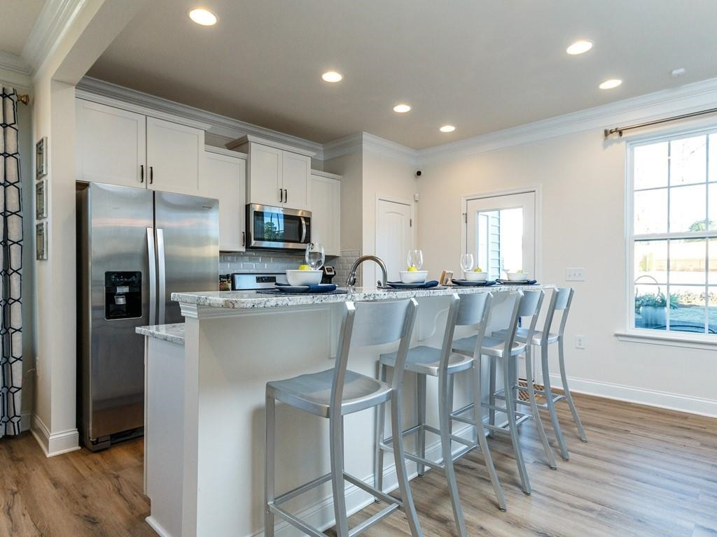 711 Rdg Clf Lane Zebulon, NC 27597 - Photo 5 of 9 a kitchen with stainless steel appliances granite countertop a refrigerator a stove top oven a sink dishwasher and a refrigerator