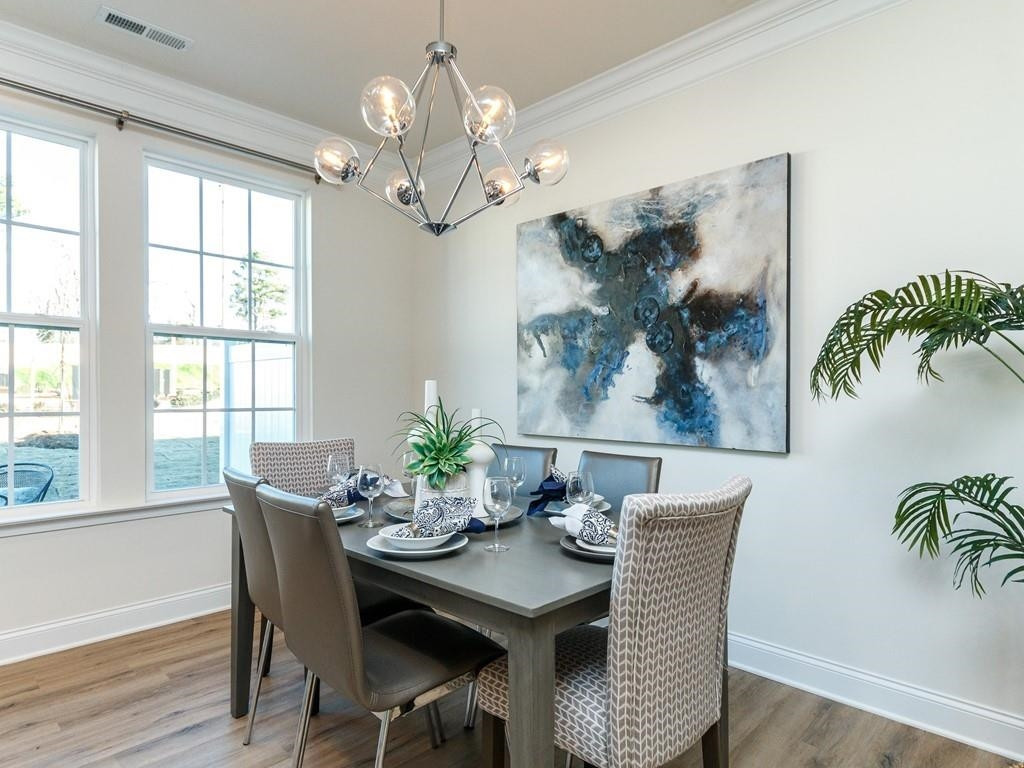 711 Rdg Clf Lane Zebulon, NC 27597 - Photo 6 of 9 a view of a dining room with furniture a chandelier and wooden floor
