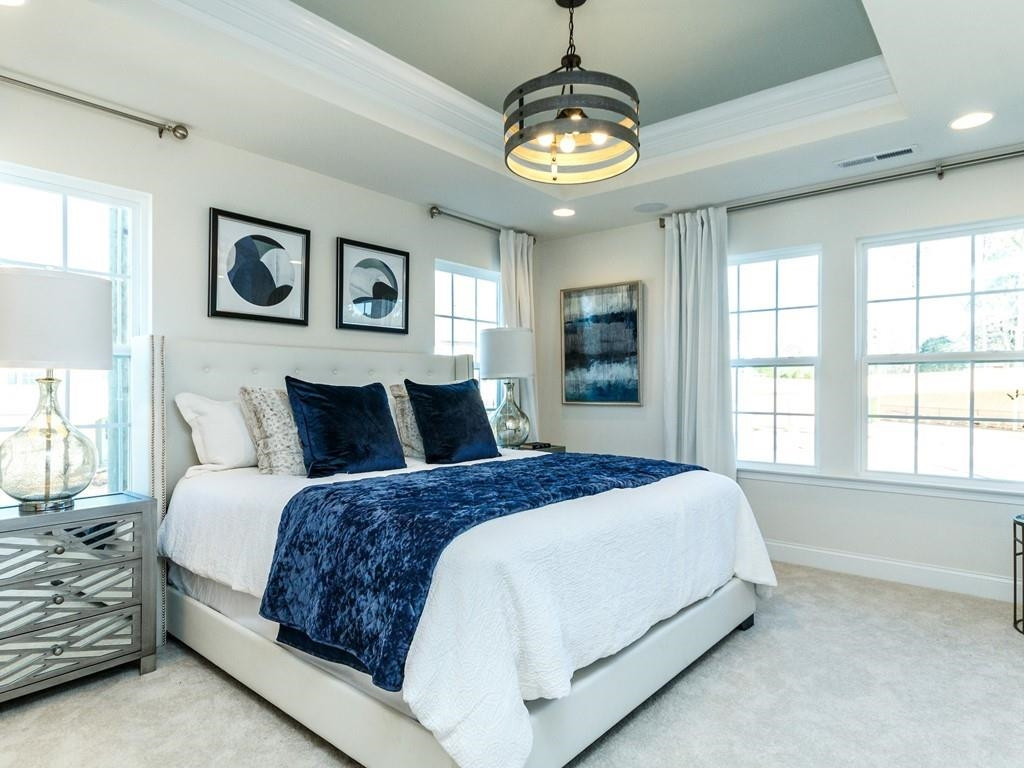 711 Rdg Clf Lane Zebulon, NC 27597 - Photo 7 of 9 a spacious bedroom with a bed and a window