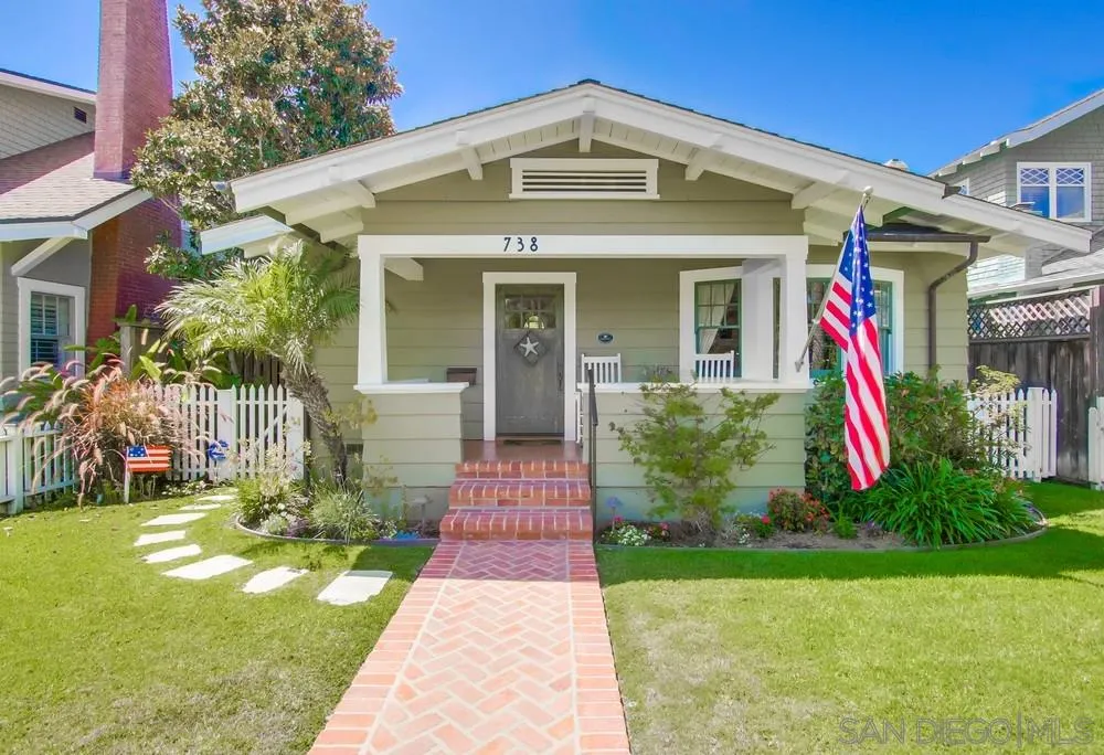738 B Avenue Coronado, CA 92118 - Photo 1 of 25 a front view of a house with a yard and potted plants