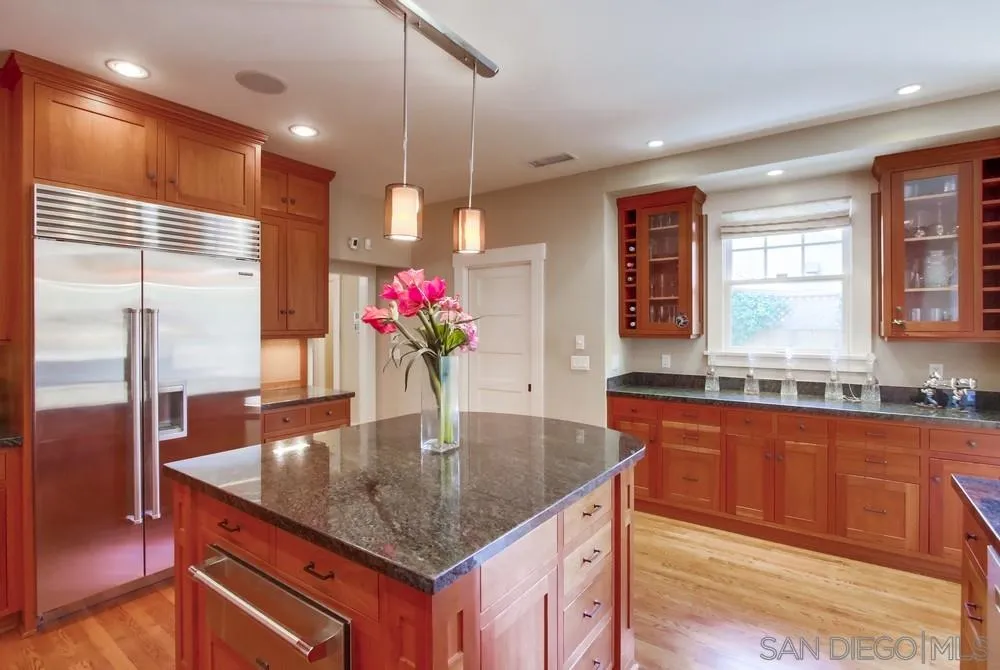 738 B Avenue Coronado, CA 92118 - Photo 11 of 25 a kitchen with kitchen island granite countertop a sink a counter top space and stainless steel appliances