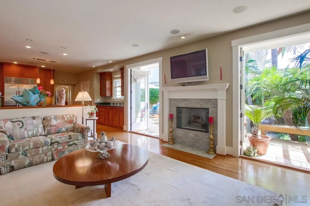 738 B Avenue Coronado, CA 92118 - Photo 15 of 25 a living room with furniture a fireplace and a floor to ceiling window