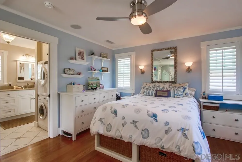 738 B Avenue Coronado, CA 92118 - Photo 20 of 25 a bedroom with a bed a chandelier and dresser