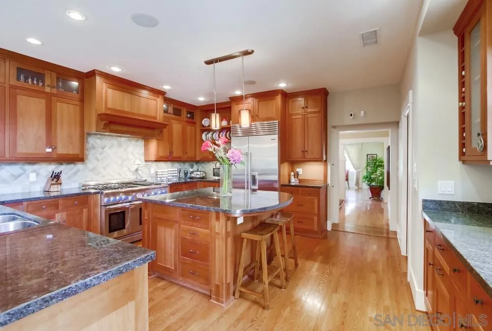 738 B Avenue Coronado, CA 92118 - Photo 10 of 25 a kitchen with stainless steel appliances granite countertop wooden cabinets a stove top oven a sink and dishwasher