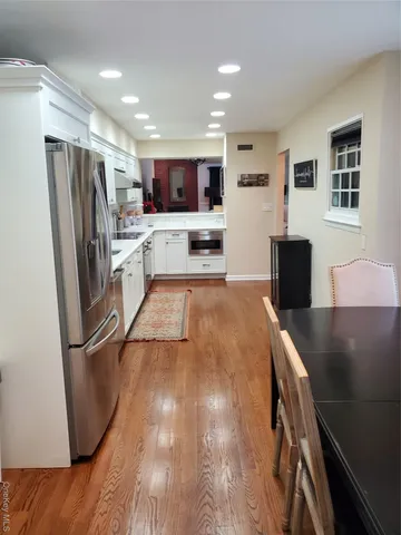 a kitchen with stainless steel appliances granite countertop a refrigerator and a stove