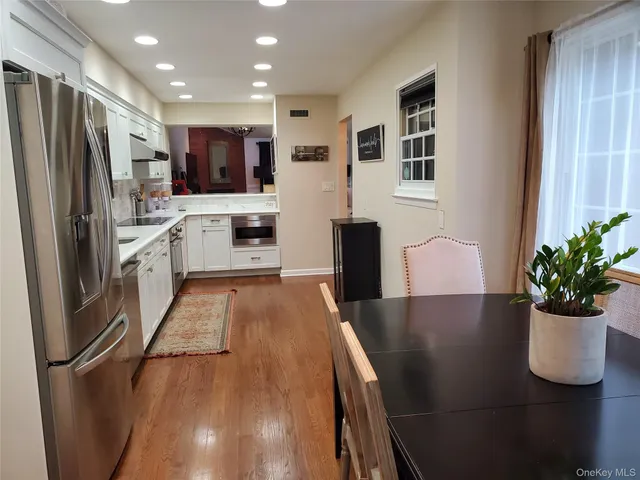 a kitchen with stainless steel appliances granite countertop a refrigerator a stove top oven a sink and dishwasher