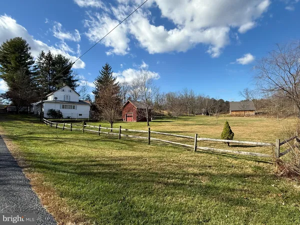 a view of a house with a yard and garage