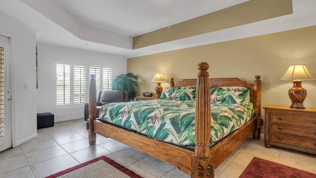 a bedroom with a bed and a painting on the wall