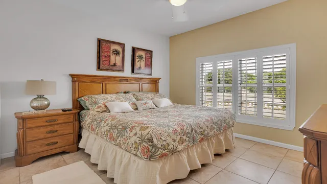 a large bed sitting in a bedroom next to a window