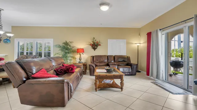a living room with furniture and a potted plant