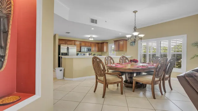 a view of a dining room with furniture and chandelier
