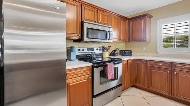 a kitchen with stainless steel appliances granite countertop a stove and a microwave