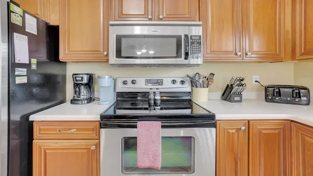 a kitchen with stainless steel appliances granite countertop a stove a microwave and cabinets