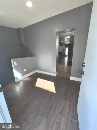 wooden floor in a hall with an empty room