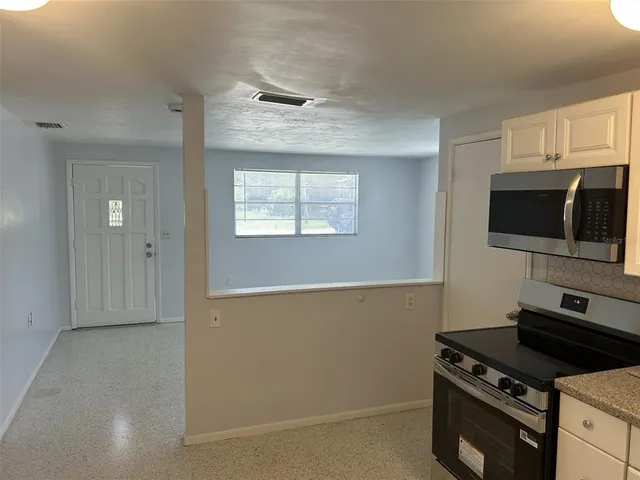 a kitchen with a stove and a microwave