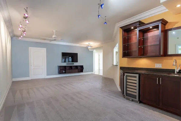a view of an empty room with a kitchen