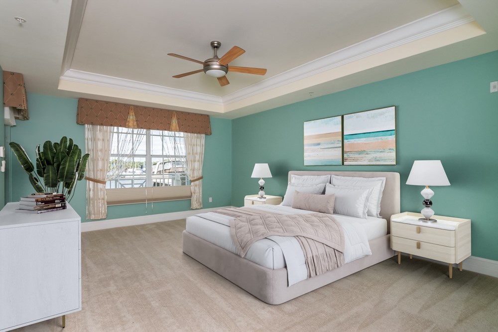 2240 Front Street, Unit 103 Melbourne, FL 32901 - Photo 16 of 31 a bedroom with a bed and a chandelier