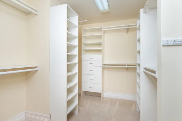 a spacious bathroom with a double vanity sink a large mirror and a shower