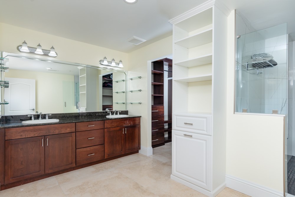 2240 Front Street, Unit 103 Melbourne, FL 32901 - Photo 18 of 31 a spacious bathroom with a double vanity sink a large mirror and a shower