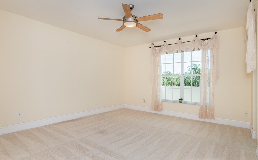 2240 Front Street, Unit 103 Melbourne, FL 32901 - Photo 22 of 31 an empty room with a window and a fan