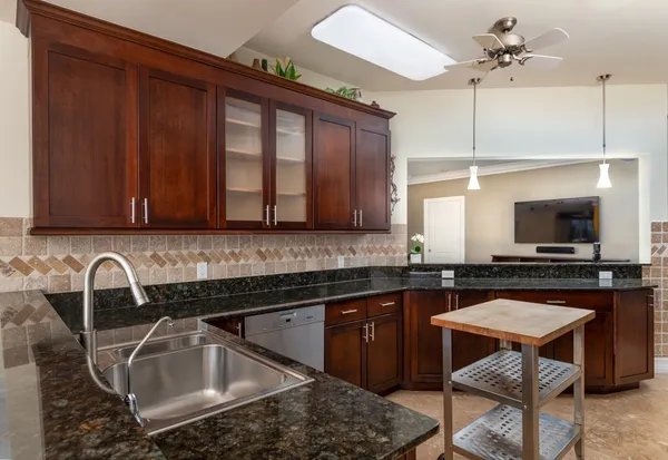 a kitchen with a sink cabinets and stainless steel appliances