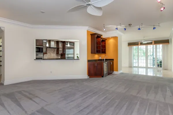 a view of an empty room with window and cabinet