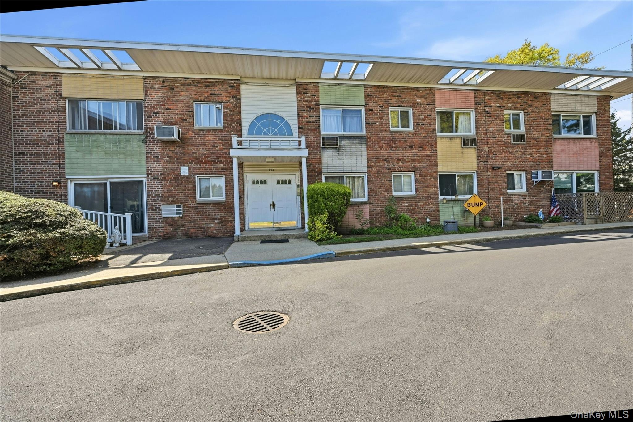 263 North Newbridge Road, Unit 1C Levittown, NY 11756 - Photo 1 of 19 front view of a brick house with a street