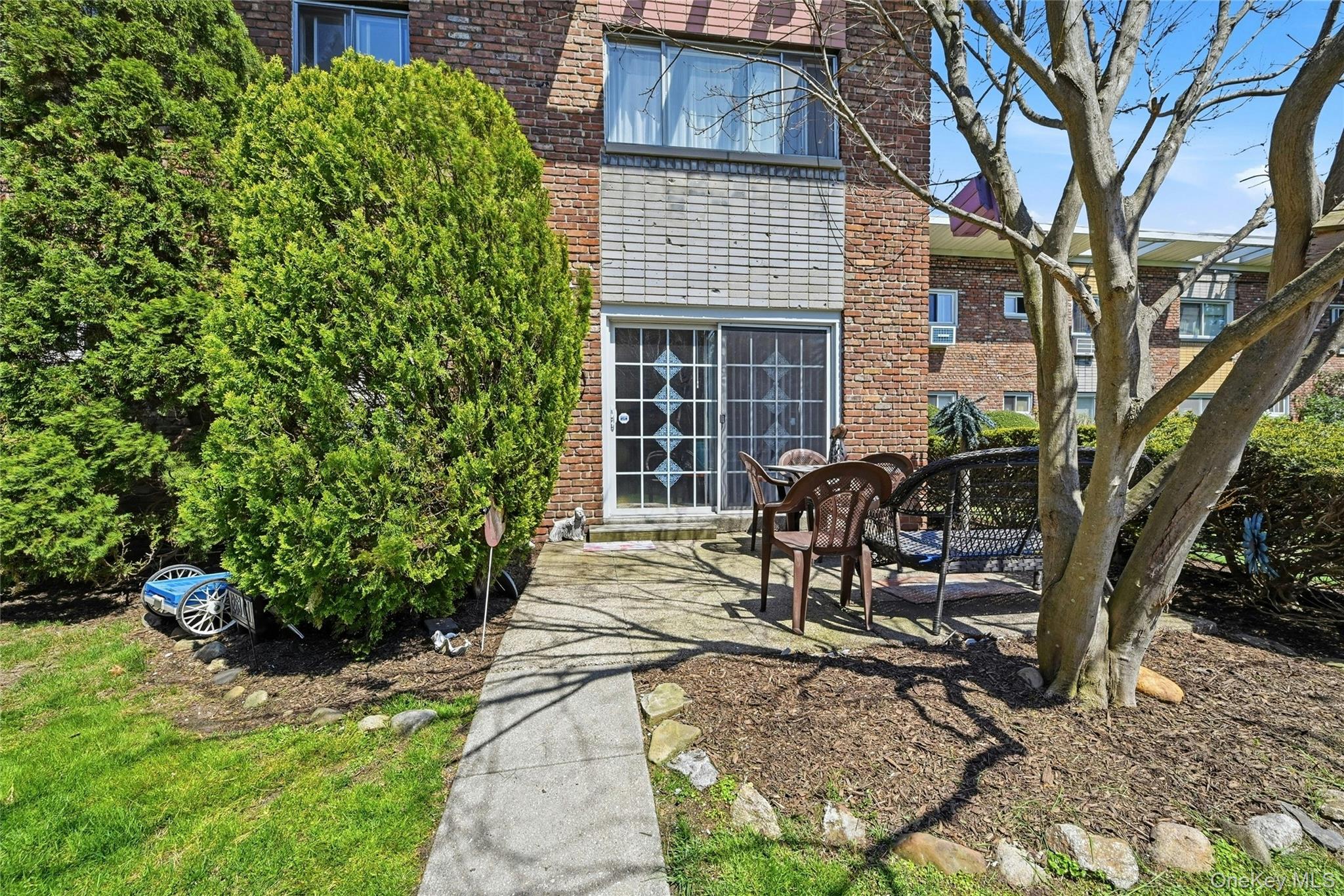 263 North Newbridge Road, Unit 1C Levittown, NY 11756 - Photo 12 of 19 a view of house with backyard and sitting area