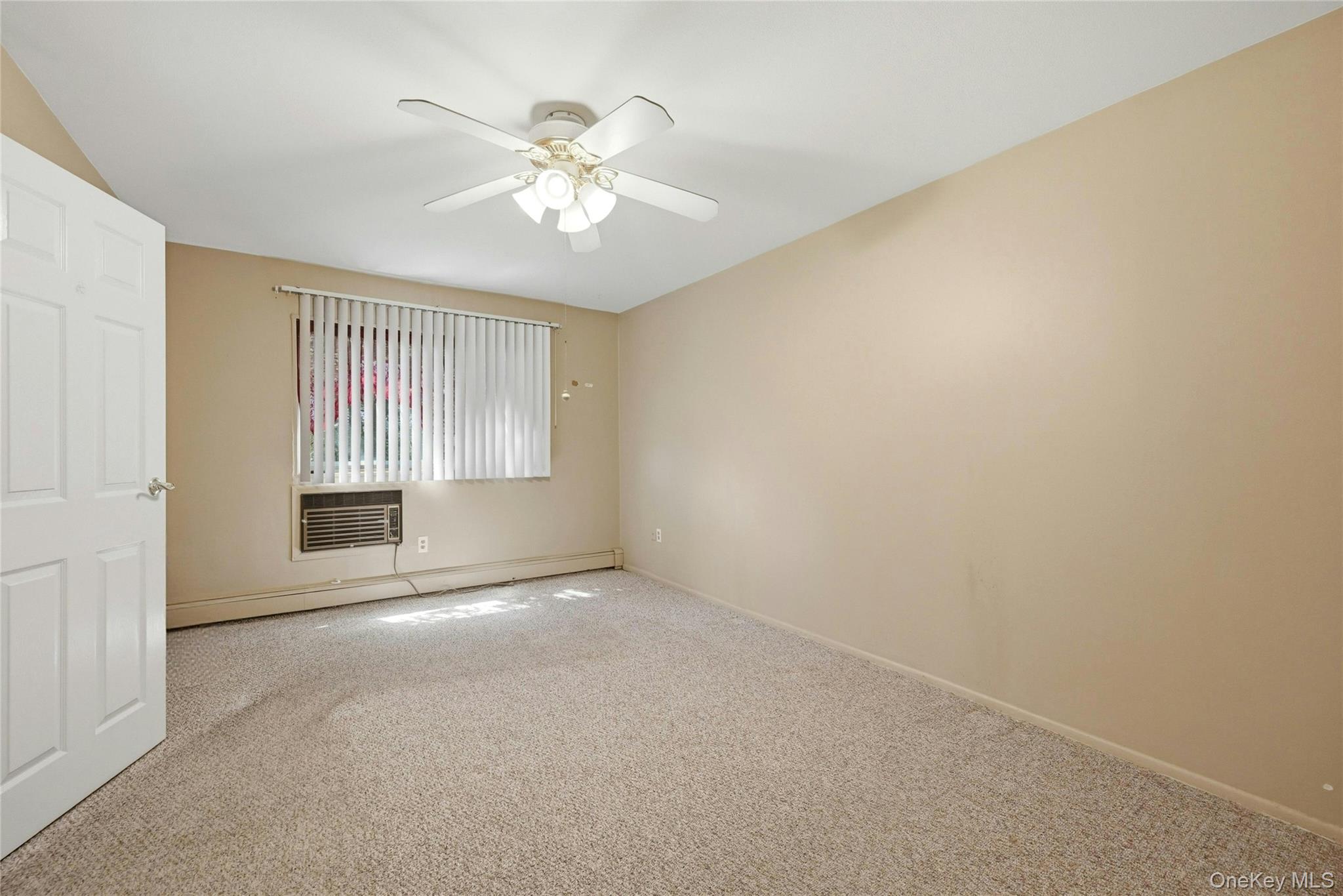263 North Newbridge Road, Unit 1C Levittown, NY 11756 - Photo 13 of 19 a view of an empty room with a window