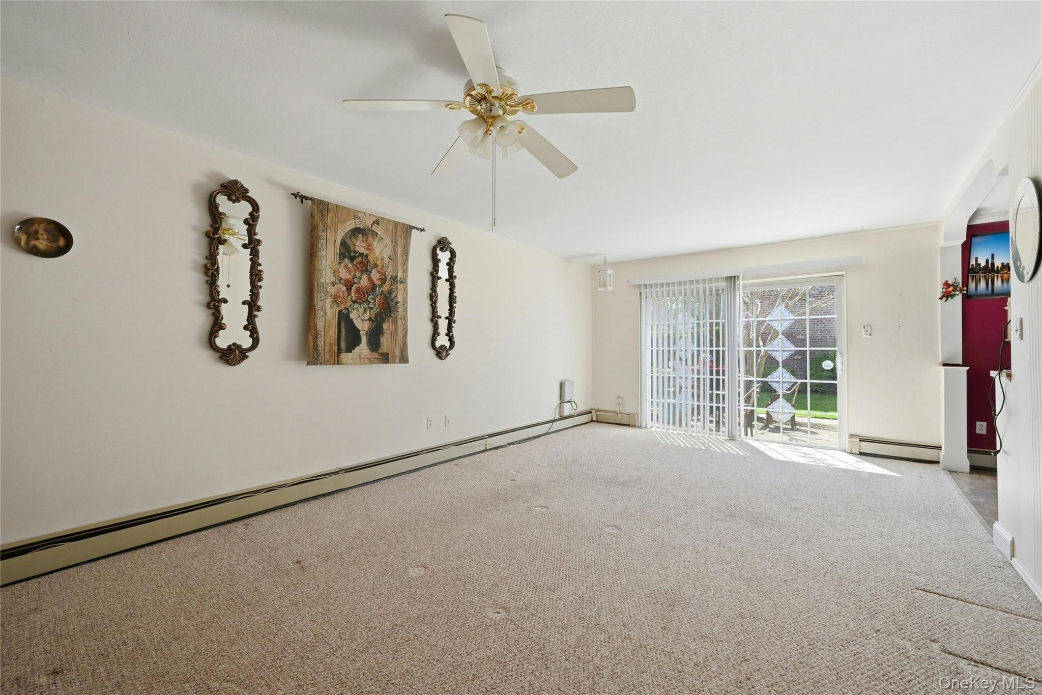 263 North Newbridge Road, Unit 1C Levittown, NY 11756 - Photo 2 of 19 an empty room with windows and fan