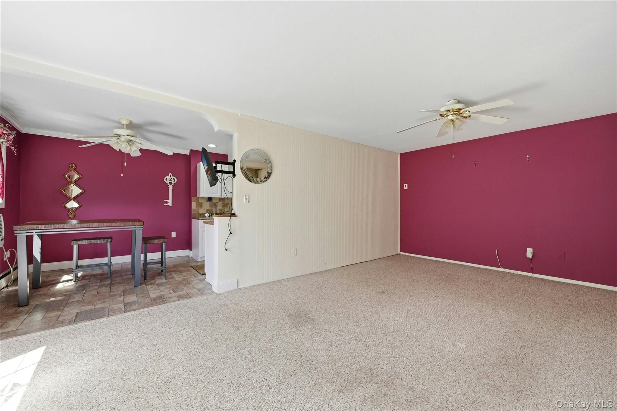 263 North Newbridge Road, Unit 1C Levittown, NY 11756 - Photo 3 of 19 a view of a livingroom with a red chair