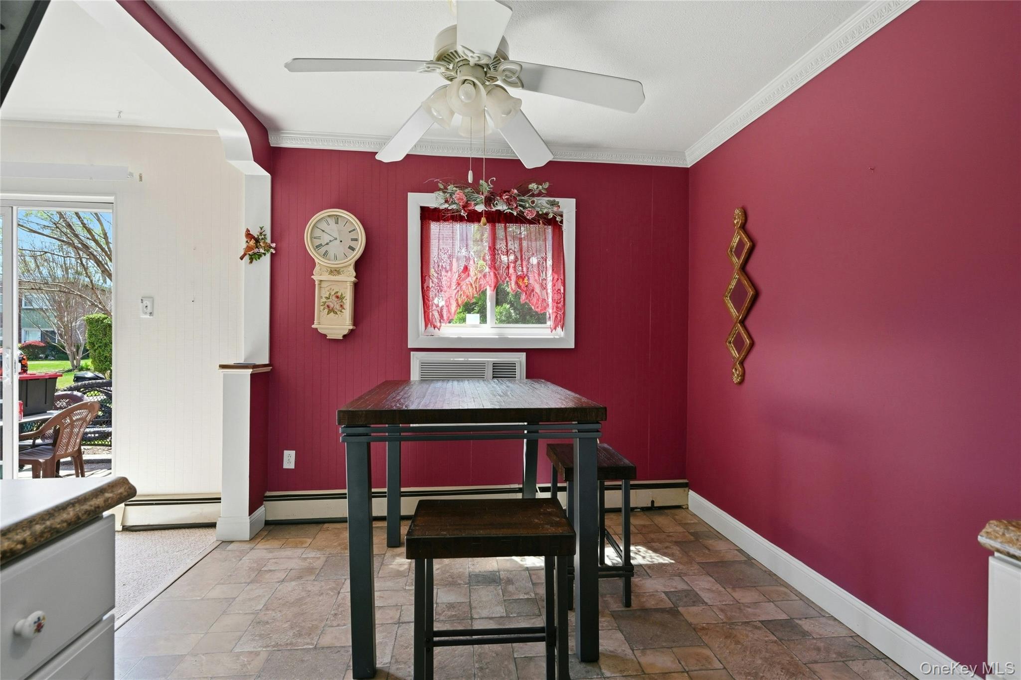 263 North Newbridge Road, Unit 1C Levittown, NY 11756 - Photo 5 of 19 a dining room with wooden table and paintings on the wall