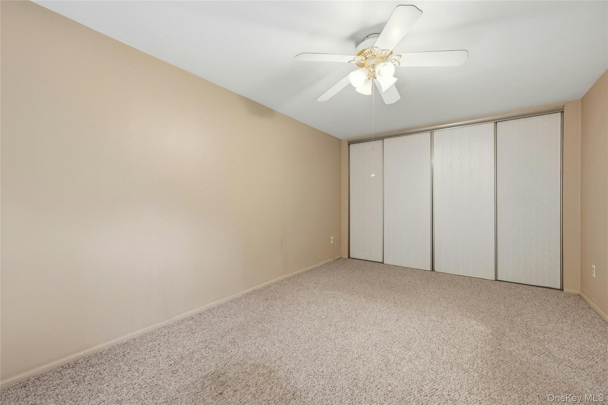 263 North Newbridge Road, Unit 1C Levittown, NY 11756 - Photo 9 of 19 a view of an empty room with a chandelier fan