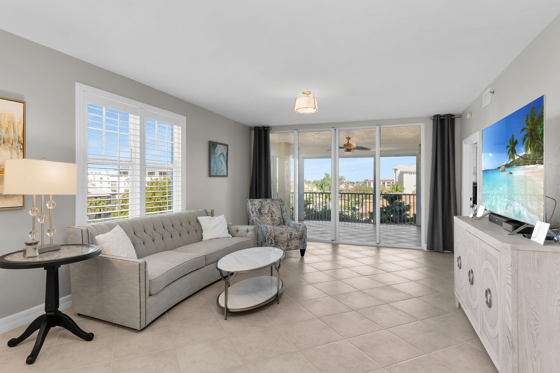 1111 Swallow Avenue, Unit 1401 Marco Island, FL 34145 - Photo 14 of 36 a living room with furniture a flat screen tv and a large window