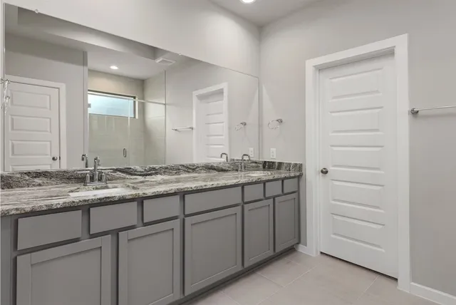 a bathroom with a shower and a sink