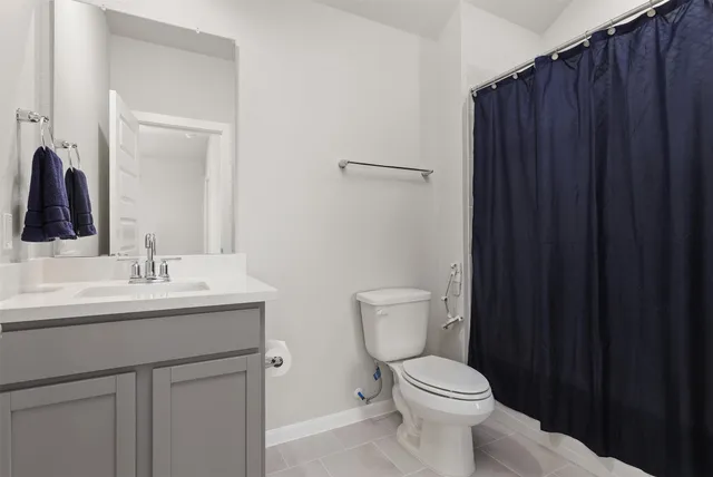 a bed sitting in a bedroom and dresser