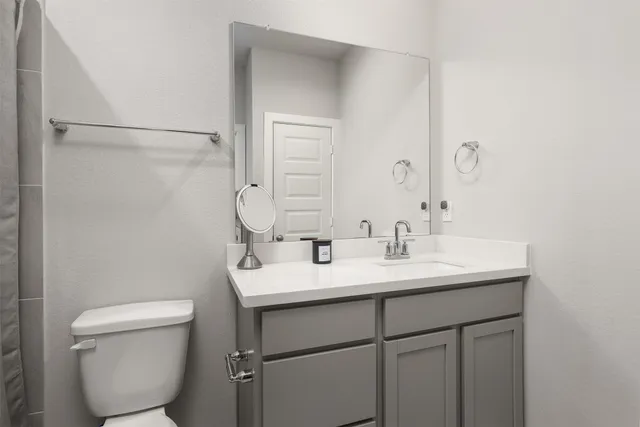 a bathroom with a shower and a toilet