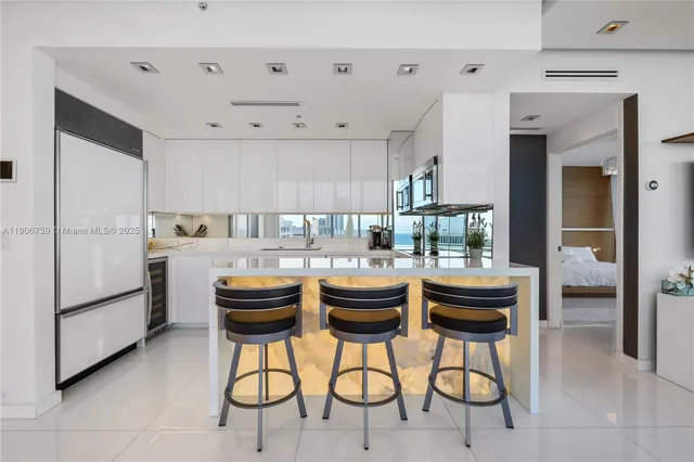 a living room with kitchen furniture and a dining table