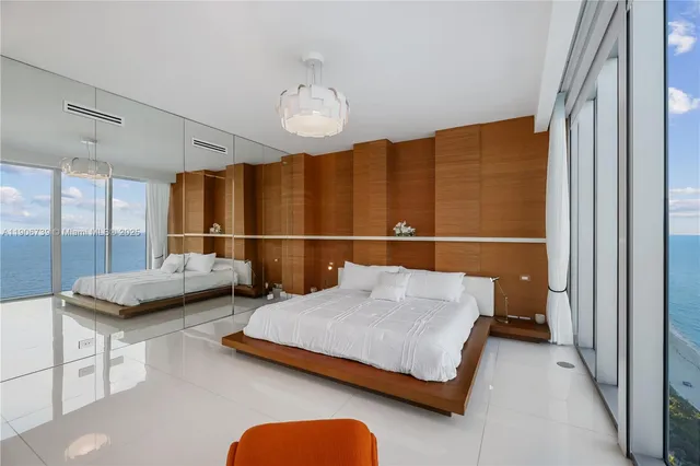 a bedroom with a large bed and a balcony