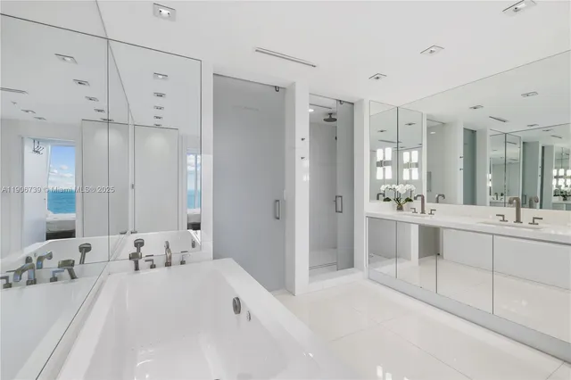a bathroom with a sink a toilet a mirror and shower