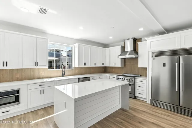 a bathroom with a double vanity sink mirror and